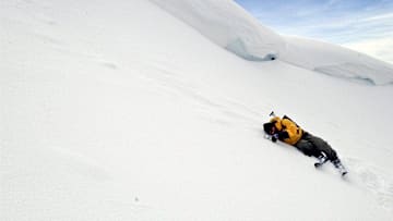 Ski patrol member Scott Cecchi checks the slope angle in a section of the backcountry near Castle Peak on Jan. 9, 2004. Cecchi is directly under the cornice where an avalanche on New Year's Day 2004 killed Drew Gashler. While Cecchi is exactly where you do not want to be during a wind or weather event, several days of melt-freeze conditions solidified the snowpack enough to safely take reading below the cornice.

Ski patrol member Scott Cecchi Castle Peak slope