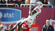 Auburn Tigers wide receiver Courtney Taylor makes an acrobatic catch over Nebraska Cornhuskers cornerback Cortney Grixby at the Cotton Bowl.