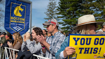 Abby Burke, Mike Burke, and Kate Michaw, of Hopkinton, cheer on runners at the start of the 129th running of the Boston Marathon, April 21, 2025.