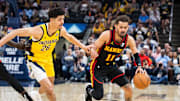 Apr 14, 2024; Indianapolis, Indiana, USA; Atlanta Hawks guard Trae Young (11) dribbles the ball while  Indiana Pacers guard Ben Sheppard (26) defends in the second half at Gainbridge Fieldhouse. Mandatory Credit: Trevor Ruszkowski-Imagn Images