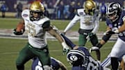 Dec 18, 2021; Shreveport, LA, USA; UAB Blazers running back DeWayne McBride (22) breaks a tackle against the BYU Cougars linebacker Max Tooley (31) during the fourth quarter during the 2021 Independence Bowl at Independence Stadium. Mandatory Credit: Petre Thomas-Imagn Images