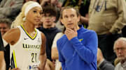 Dallas Wings guard DiJonai Carrington (21) talks to head coach Chris Koclanes as they play the Minnesota Lynx in the fourth quarter at Target Center.