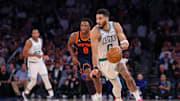 May 12, 2025; New York, New York, USA; Boston Celtics forward Jayson Tatum (0) dribbles up court in front of New York Knicks forward OG Anunoby (8) in the second half during game four of the second round for the 2025 NBA Playoffs at Madison Square Garden. Mandatory Credit: Vincent Carchietta-Imagn Images