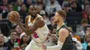 Dec 21, 2024; Minneapolis, Minnesota, USA; Golden State Warriors forward Andrew Wiggins (22) backs towards the basket as Minnesota Timberwolves guard Donte DiVincenzo (0) plays defense in the first half at Target Center. Mandatory Credit: Jesse Johnson-Imagn Images