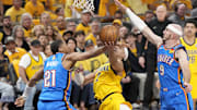 Jun 11, 2025; Indianapolis, Indiana, USA; Oklahoma City Thunder guard Aaron Wiggins (21) and guard Alex Caruso (9) block the shot of Indiana Pacers guard Andrew Nembhard (2) during the first half of game three of the 2025 NBA Finals at Gainbridge Fieldhouse. Mandatory Credit: Kyle Terada-Imagn Images