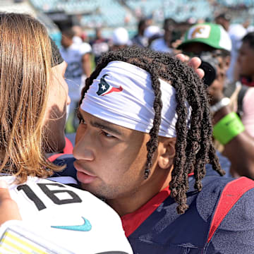 Sep 24, 2023; Jacksonville, Florida, USA; Houston Texans quarterback CJ Stroud (7) and Jacksonville Jaguars quarterback Trevor Lawrence (16) meet at the end of the game at EverBank Stadium. Mandatory Credit: Melina Myers-Imagn Images