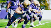 Landen and Geirean Hatchett, side by side, come out of a stance in UW spring ball.
