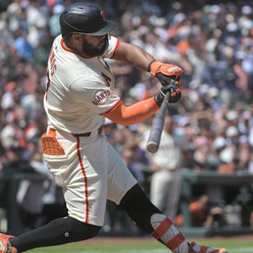 Jun 7, 2025; San Francisco, California, USA; San Francisco Giants outfielder Heliot Ramos (17) hits a single against the Atlanta Braves during the ninth inning at Oracle Park.