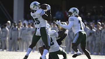 Nov 16, 2024; Annapolis, Maryland, USA;  Tulane Green Wave linebacker Sam Howard (15) catches a Navy Midshipmen tipped pass for a interception during the first half at Navy-Marine Corps Memorial Stadium. 