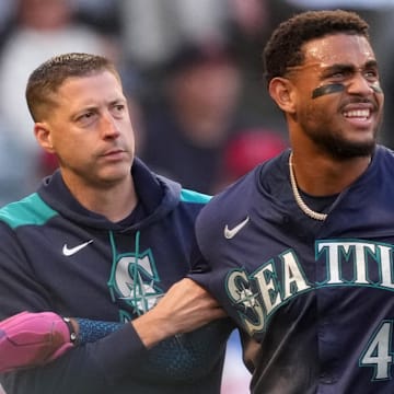Seattle Mariners outfielder Julio Rodriguez (44) is helped off the field during a game against the Los Angeles Angels on June 7 at Angel Stadium.