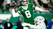 New York Jets quarterback Aaron Rodgers (8) throws a pass before Miami Dolphins linebacker Chop Robinson (44) could take him down, Sunday January 5, 2025, in East Rutherford.